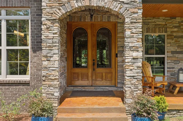 a kitchen with granite countertop a sink a counter space appliances and cabinets