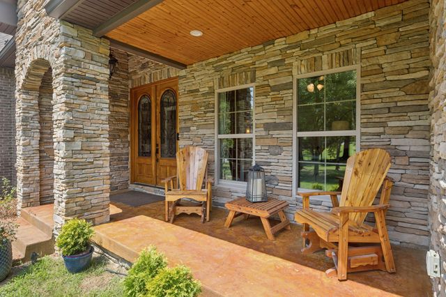 a kitchen with stainless steel appliances granite countertop a sink refrigerator and cabinets