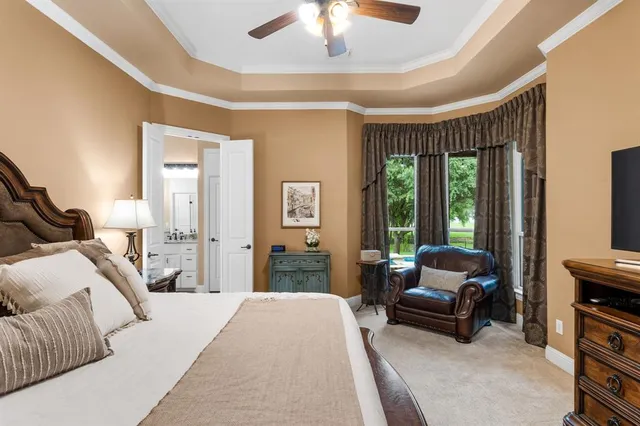 a bedroom with a bed and a dresser with mirror