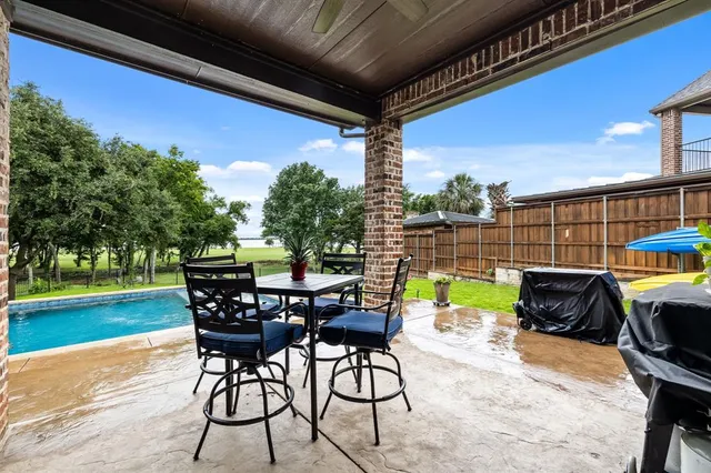 a view of a house with swimming pool and sitting area