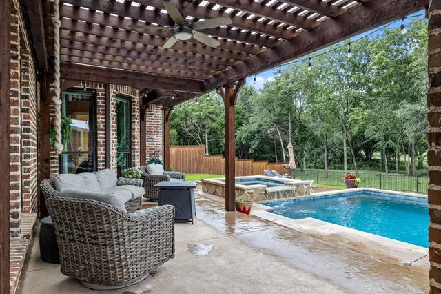 a view of a big house with plants and large trees