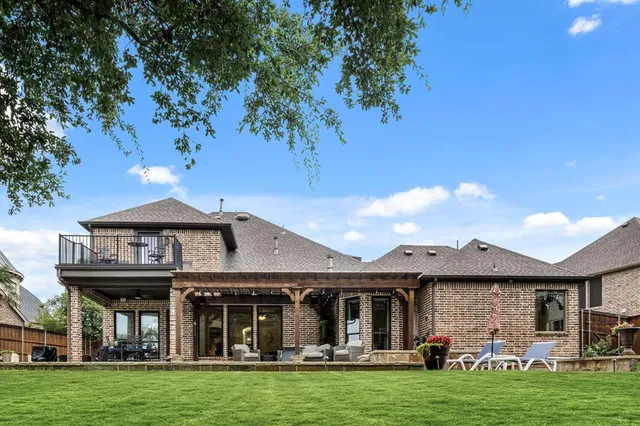 a front view of a house with a garden and yard