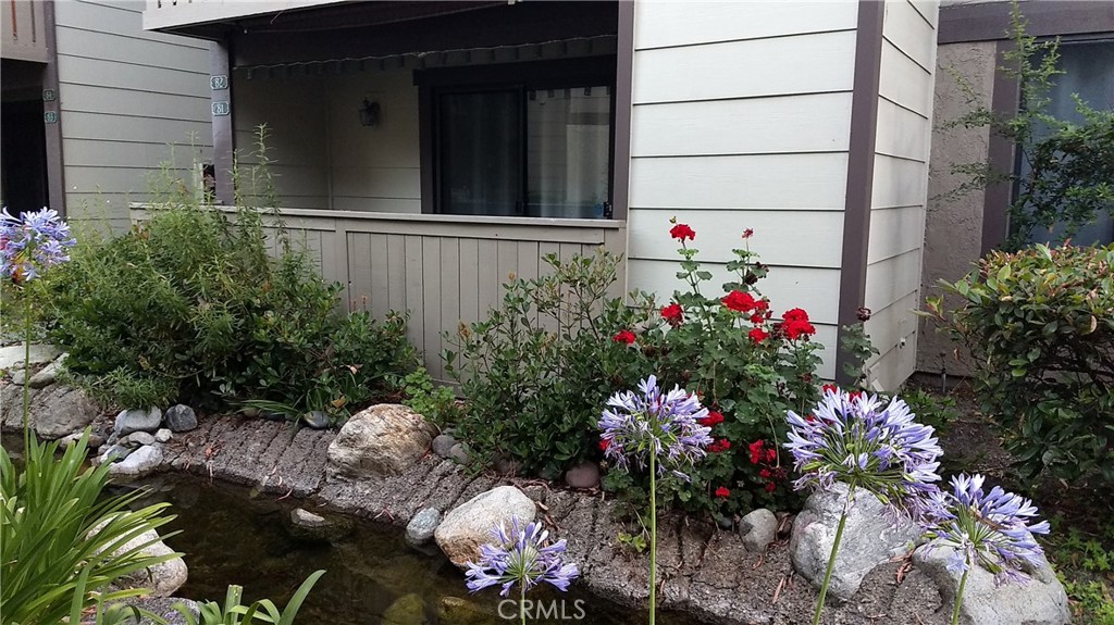 20702 El Toro Road, Unit 81 Lake Forest, CA 92630 - Photo 1 of 1 a view of a house with a flower garden
