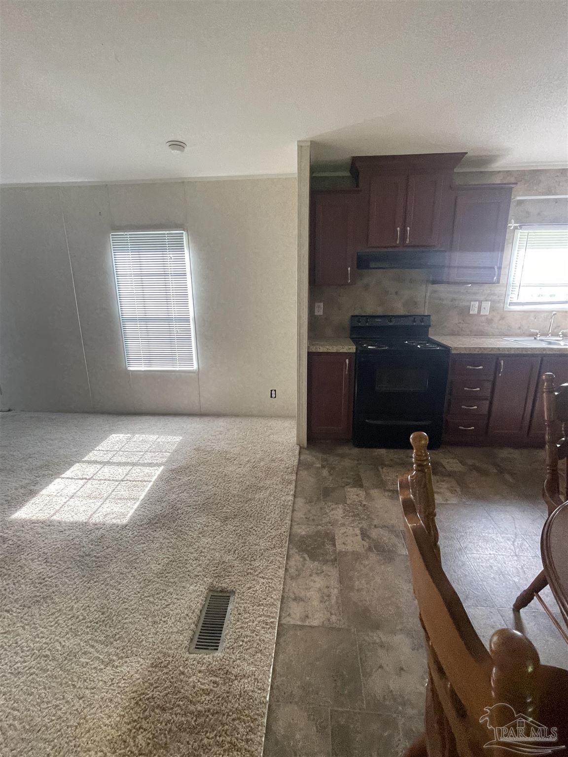 9520 Bridlewood Road Pensacola, FL 32526 - Photo 15 of 19 a room with a stove top oven a sink and a window