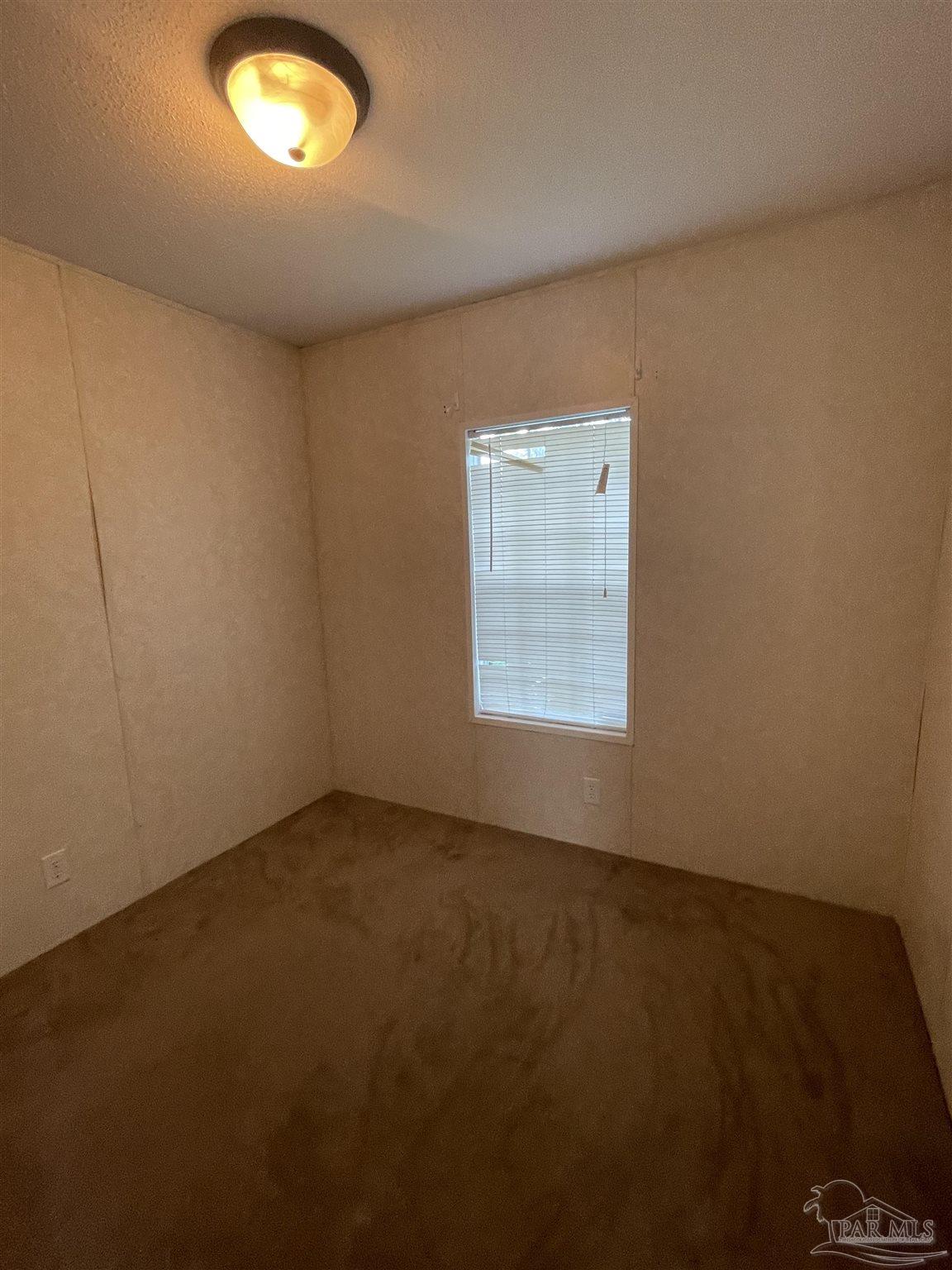 9520 Bridlewood Road Pensacola, FL 32526 - Photo 18 of 19 an empty room with a empty space and a window