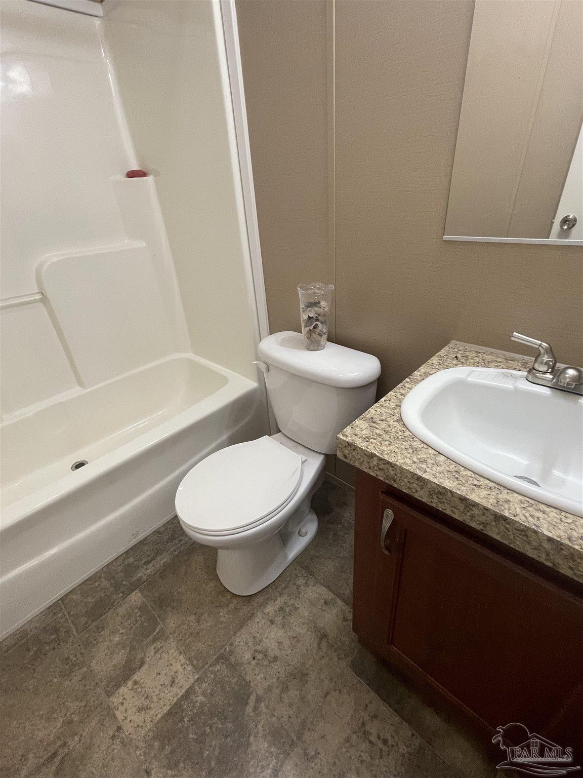 9520 Bridlewood Road Pensacola, FL 32526 - Photo 5 of 19 a bathroom with a granite countertop sink toilet and shower