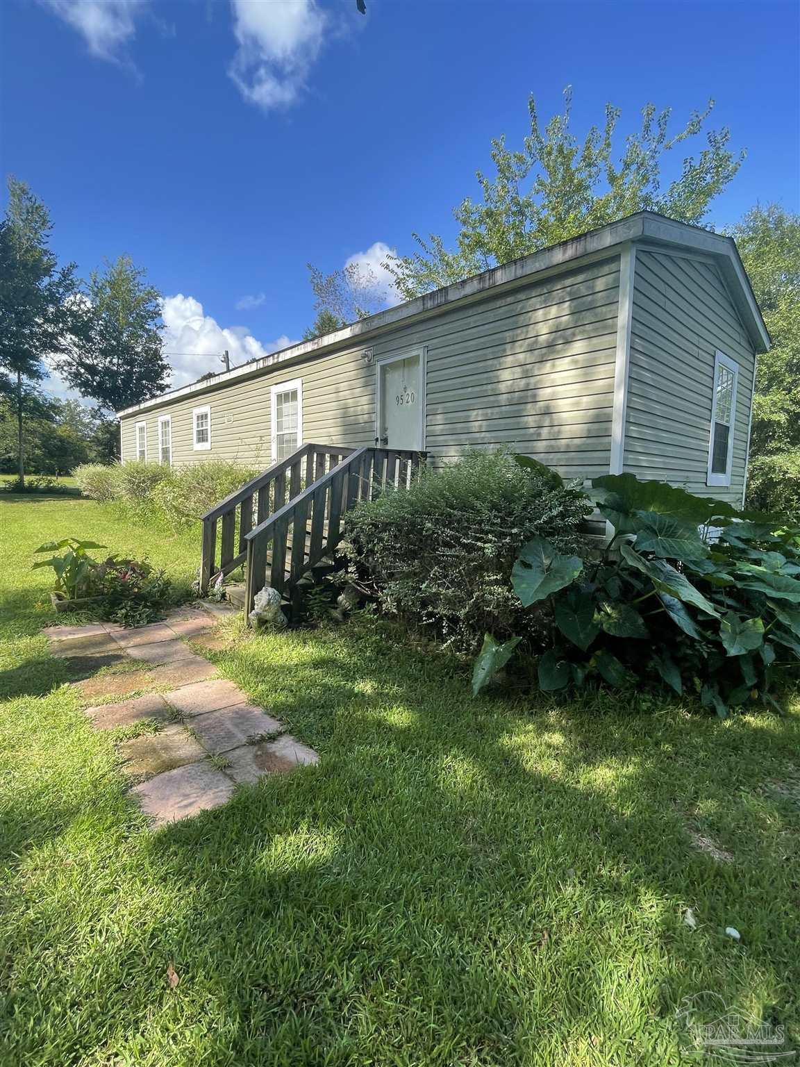 9520 Bridlewood Road Pensacola, FL 32526 - Photo 7 of 19 a backyard of a house with lots of green space