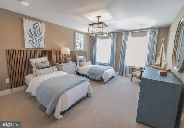 a spacious bedroom with two beds and a table