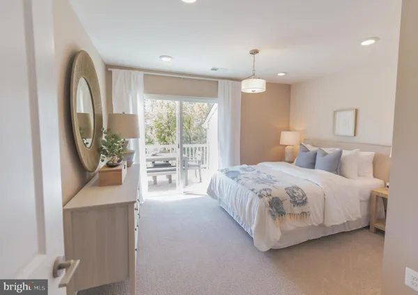 a spacious bedroom with a large bed and a chandelier