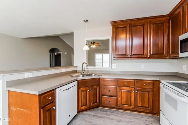 a kitchen with stainless steel appliances granite countertop a sink and cabinets