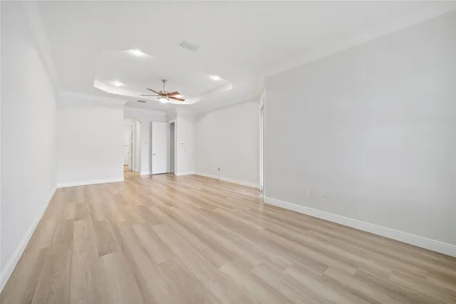 a spacious bathroom with a granite countertop sink a toilet a mirror and bathtub