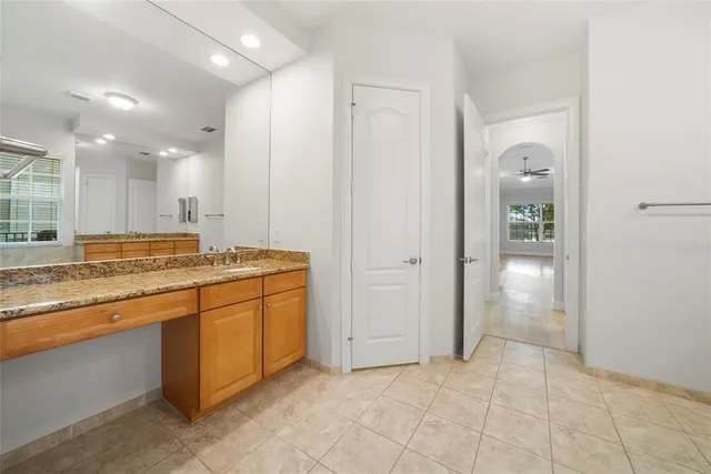 a bathroom with a granite countertop sink a toilet and bathtub