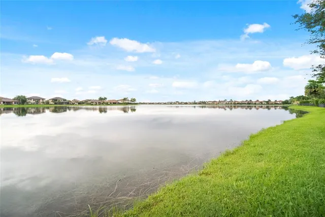 a view of a lake with houses in the back