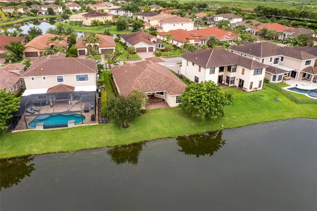 a view of an empty room with windows and wooden floor