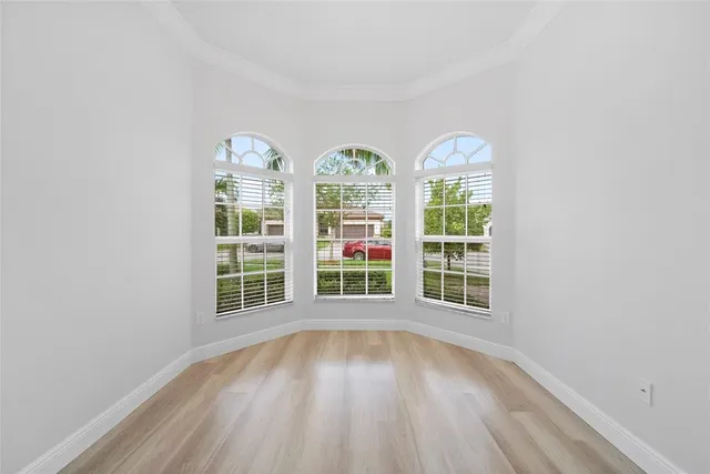 a view of a room with wooden floor and white doors