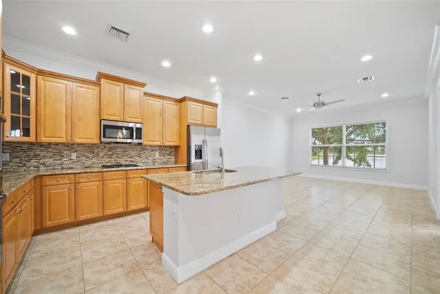 a kitchen that has a sink and a stove in it