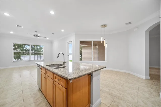 a view of a kitchen with stainless steel appliances granite countertop a refrigerator and a sink
