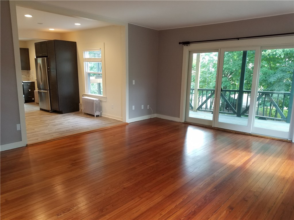 49 Merton Road, Unit 2 Newport, RI 02840 - Photo 17 of 42 Living Room/Dining Area view to sliders,& wrap around porch and kitchen