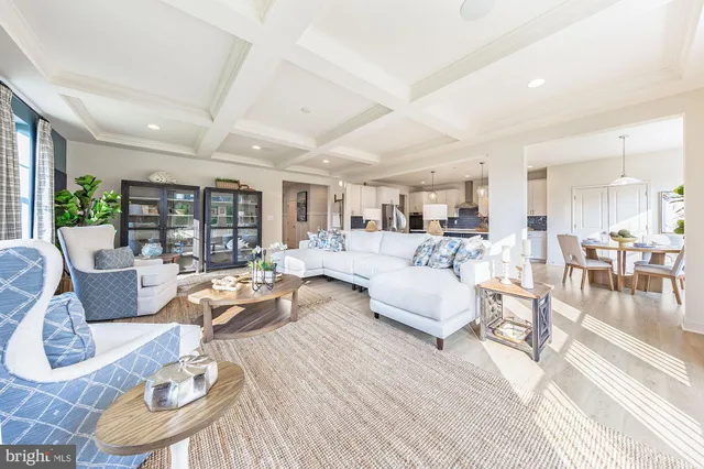 a living room with furniture wooden floor and a table