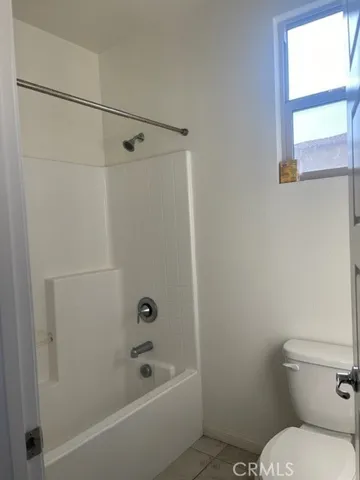a bathroom with a toilet and a bathtub