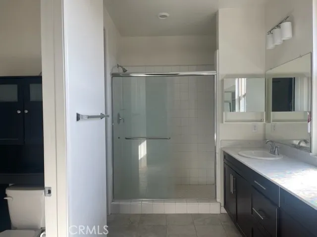 a bathroom with a shower and a sink