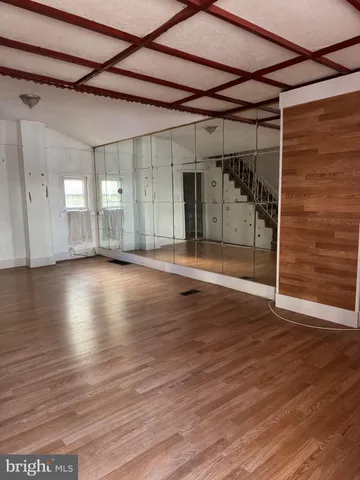 a view of a room with wooden floor