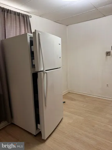 a view of kitchen with a refrigerator