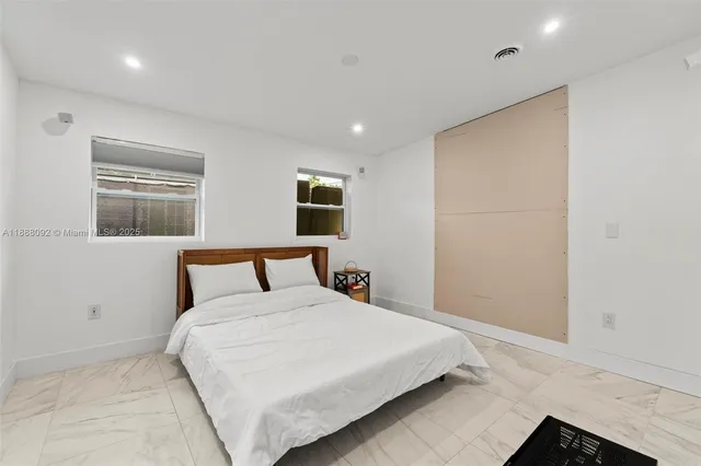 a bedroom with a large bed and a night stand