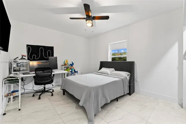 a bedroom with a bed a desk and chair