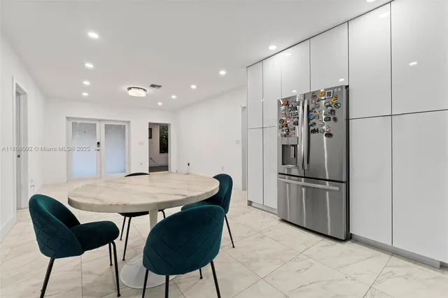 a kitchen with stainless steel appliances granite countertop a refrigerator a sink and a refrigerator