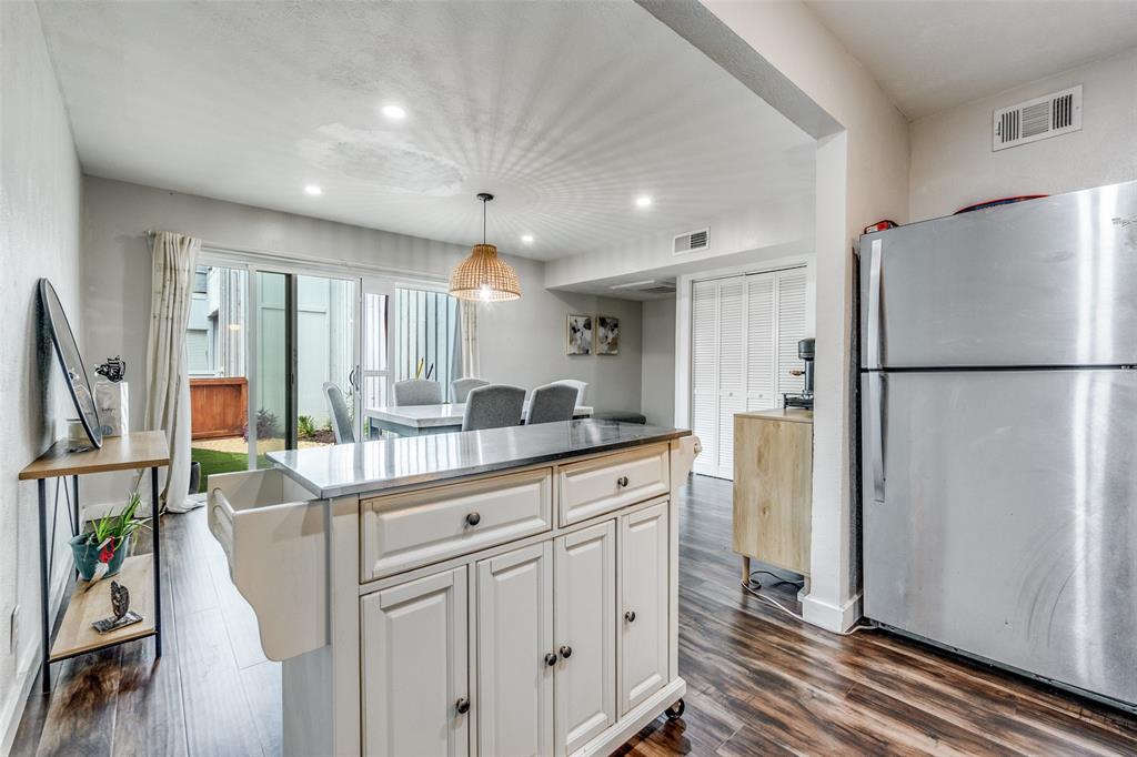 4347 Dickason Avenue, Unit 110 Dallas, TX 75219 - Photo 13 of 24 a kitchen with white cabinets and refrigerator