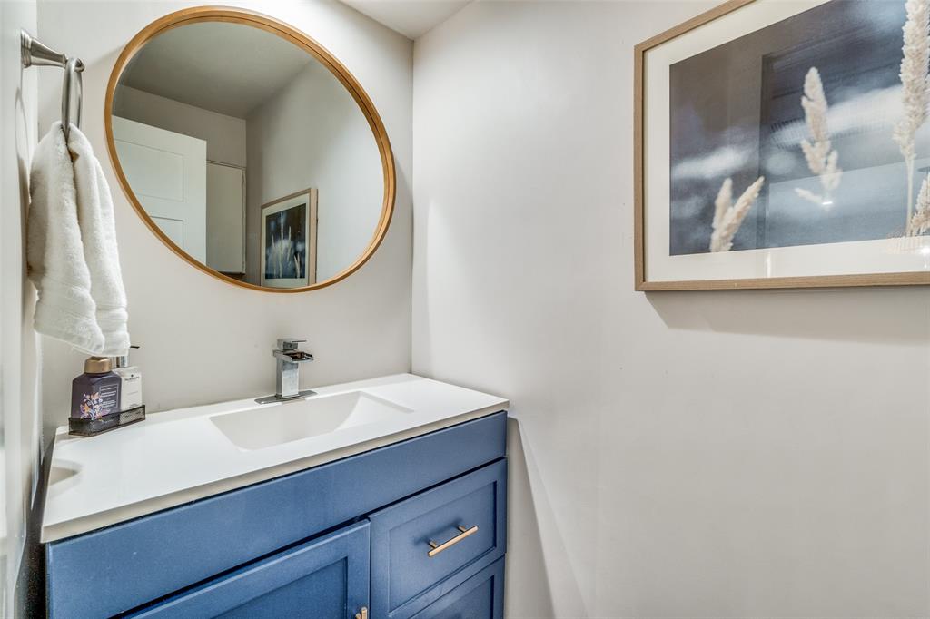 4347 Dickason Avenue, Unit 110 Dallas, TX 75219 - Photo 15 of 24 a bathroom with a sink and a mirror