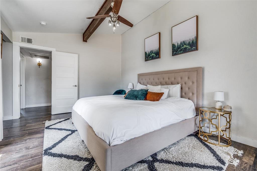 4347 Dickason Avenue, Unit 110 Dallas, TX 75219 - Photo 20 of 24 a bedroom with a bed and wooden floor