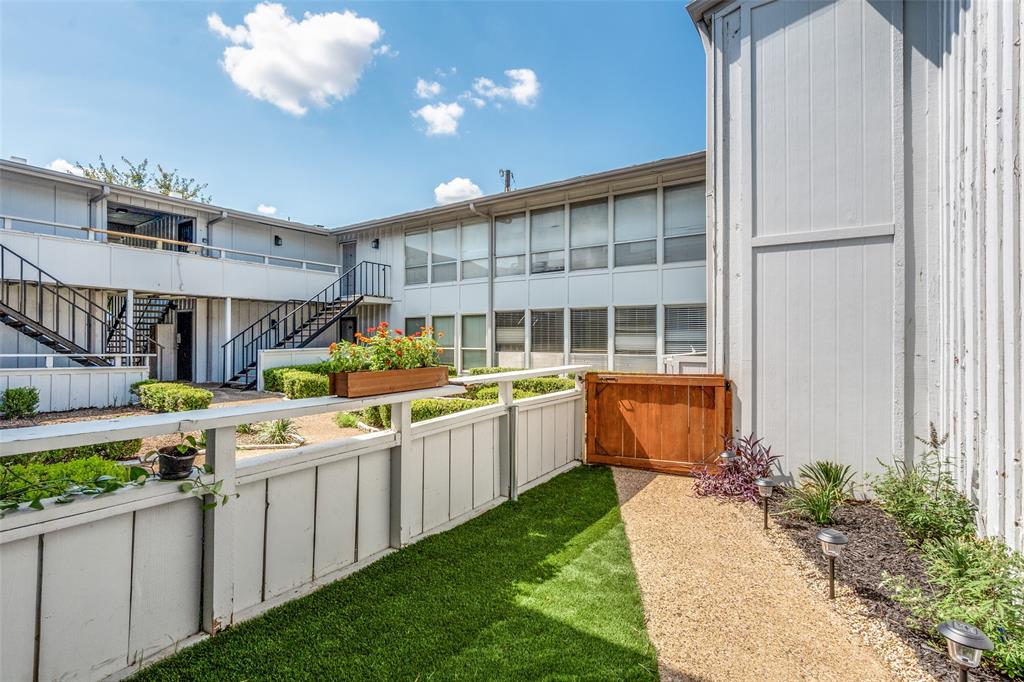 4347 Dickason Avenue, Unit 110 Dallas, TX 75219 - Photo 23 of 24 a kitchen with stainless steel appliances kitchen island granite countertop lots of green space