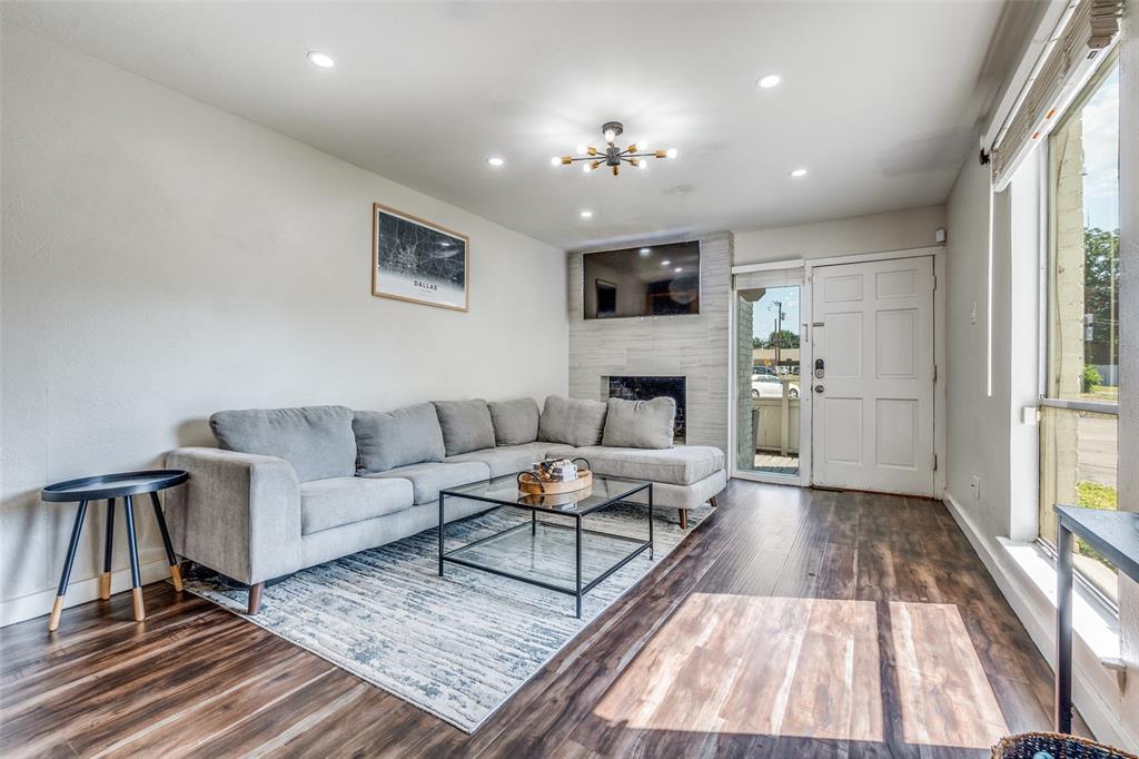 4347 Dickason Avenue, Unit 110 Dallas, TX 75219 - Photo 4 of 24 a living room with furniture and a fireplace