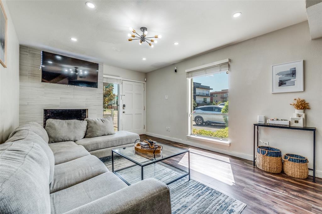 4347 Dickason Avenue, Unit 110 Dallas, TX 75219 - Photo 5 of 24 a living room with furniture and a flat screen tv