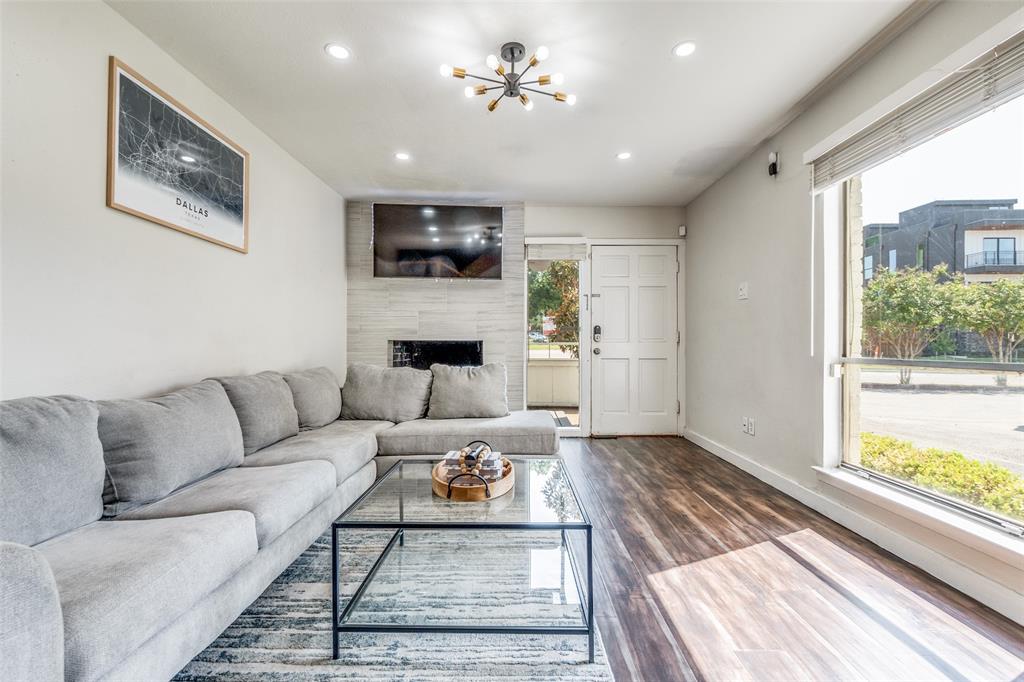 4347 Dickason Avenue, Unit 110 Dallas, TX 75219 - Photo 6 of 24 a living room with furniture and a fireplace