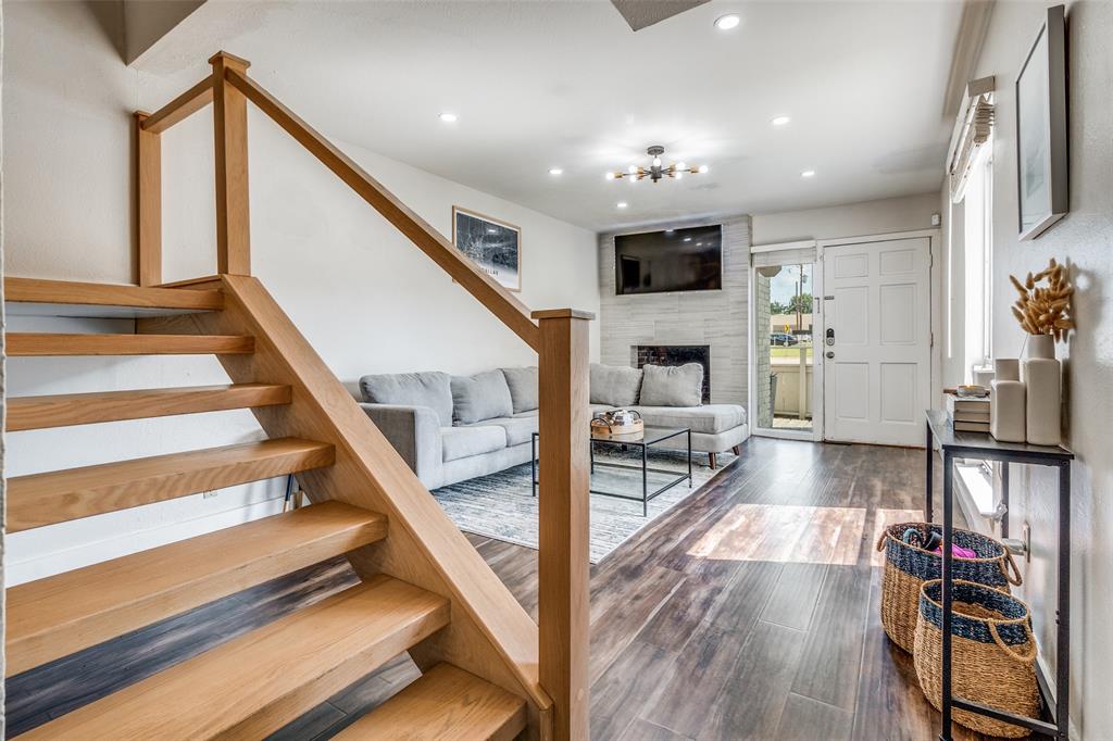 4347 Dickason Avenue, Unit 110 Dallas, TX 75219 - Photo 8 of 24 a view of a living room with wooden floor and staircase
