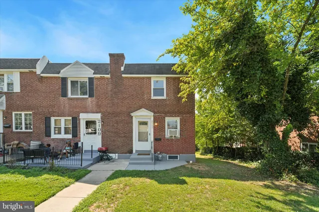 a front view of a house with garden and porch