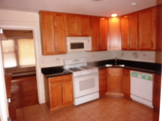 6733 West Irving Park Road, Unit 2C Chicago, IL 60634 - Photo 2 of 10 a kitchen with stainless steel appliances a stove a sink and a microwave