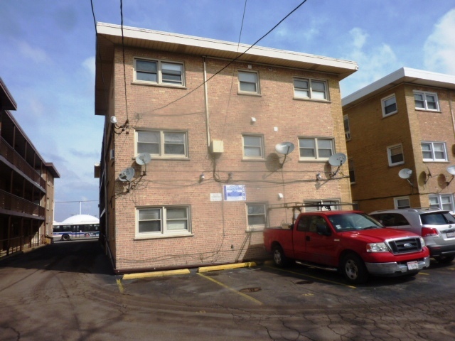 6733 West Irving Park Road, Unit 2C Chicago, IL 60634 - Photo 9 of 10 a car parked in front of a house