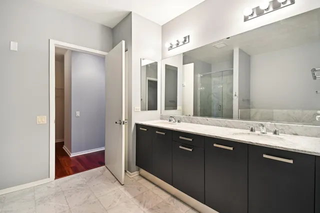 a spacious bathroom with a double vanity sink mirror and double