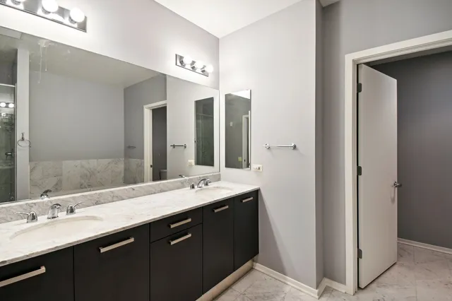 a bathroom with a double vanity sink and a mirror
