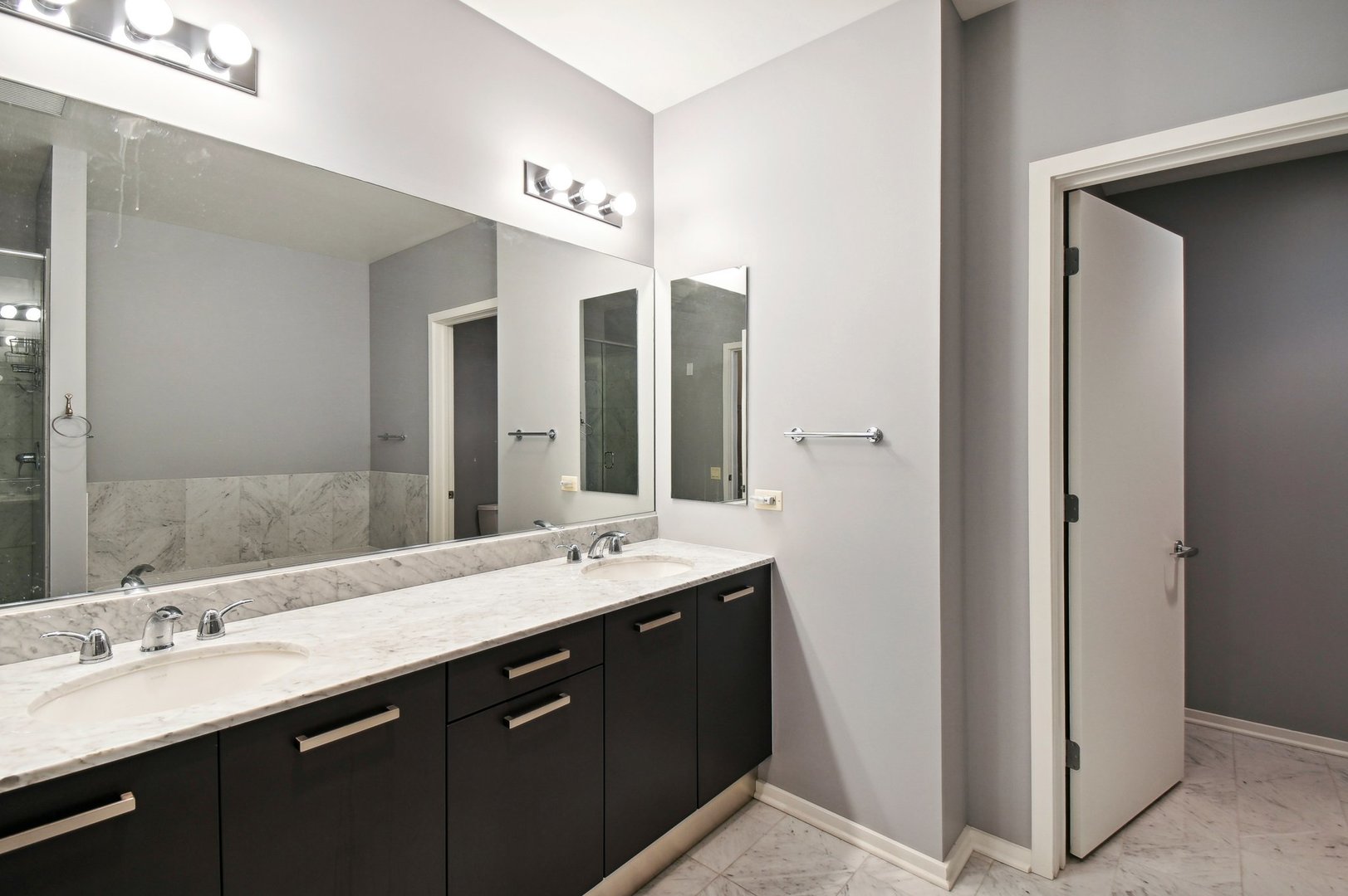 65 East Monroe Street, Unit 4521 Chicago, IL 60603 - Photo 16 of 42 a bathroom with a double vanity sink and a mirror