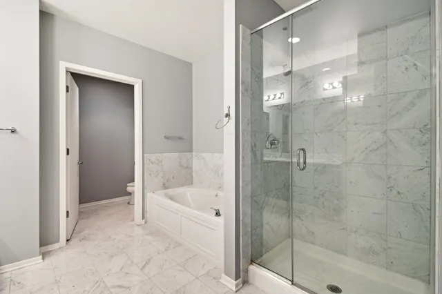 a bathroom with a bathtub and a shower
