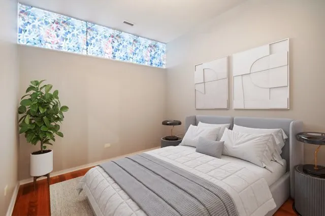 a bedroom with a bed and a potted plant