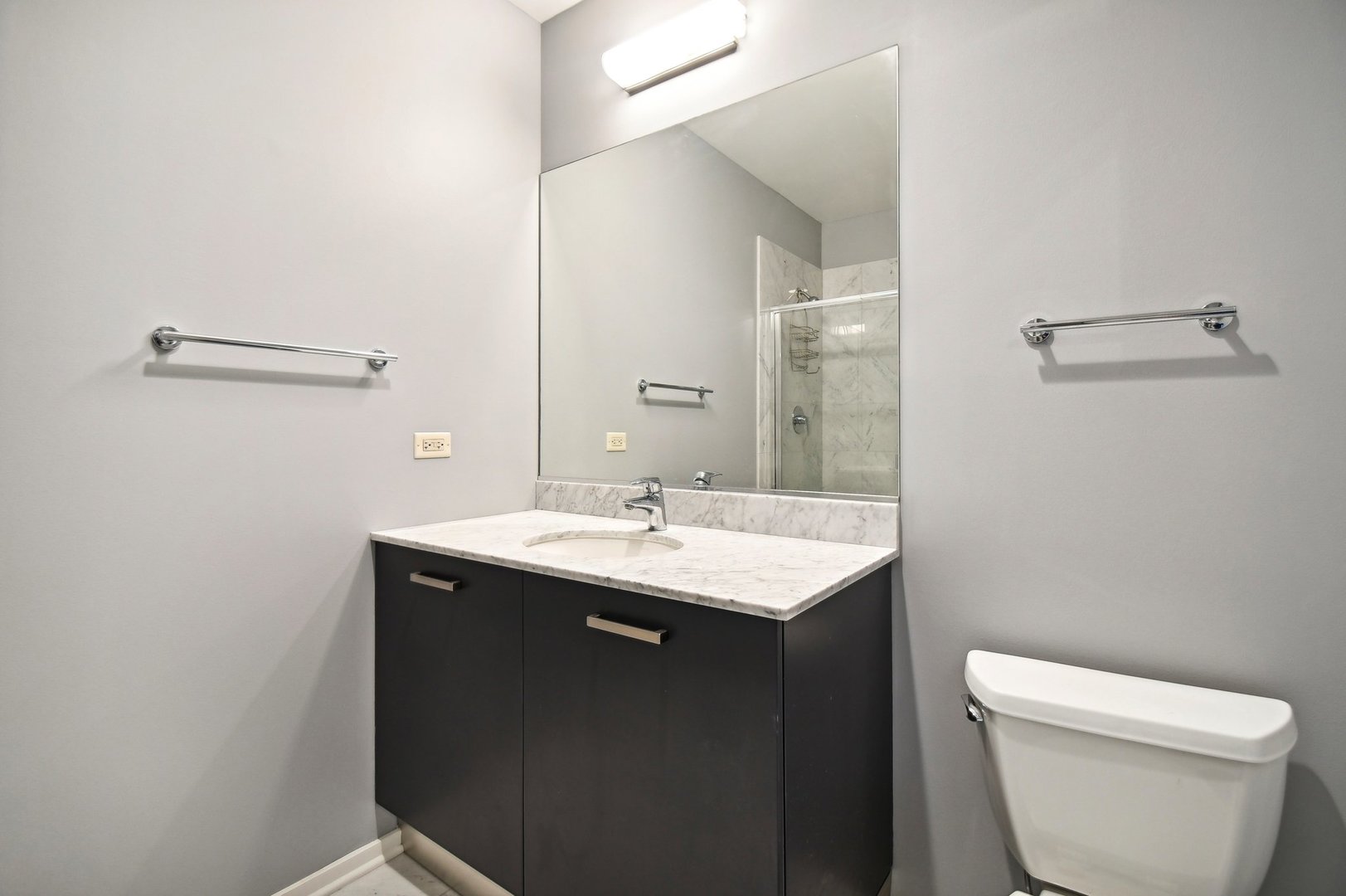 65 East Monroe Street, Unit 4521 Chicago, IL 60603 - Photo 21 of 42 a bathroom with a toilet a sink and mirror