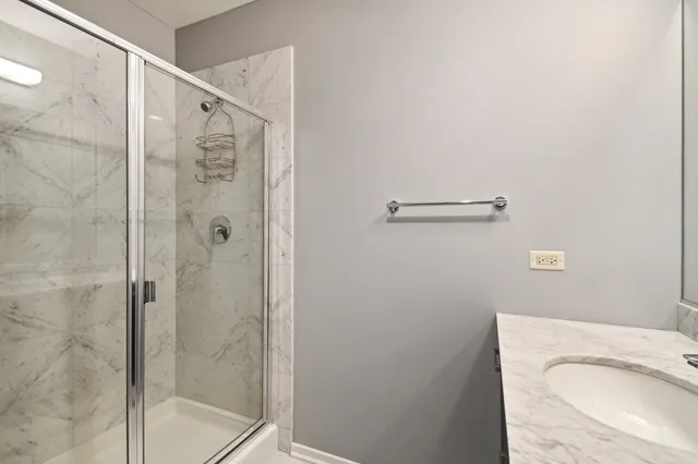 a bathroom with a shower and a sink