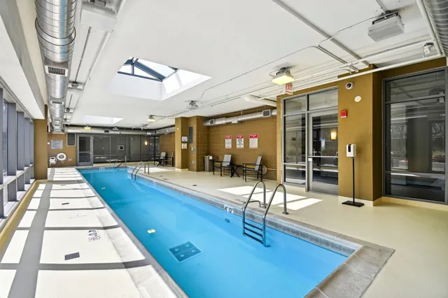 a swimming pool with outdoor seating and patio