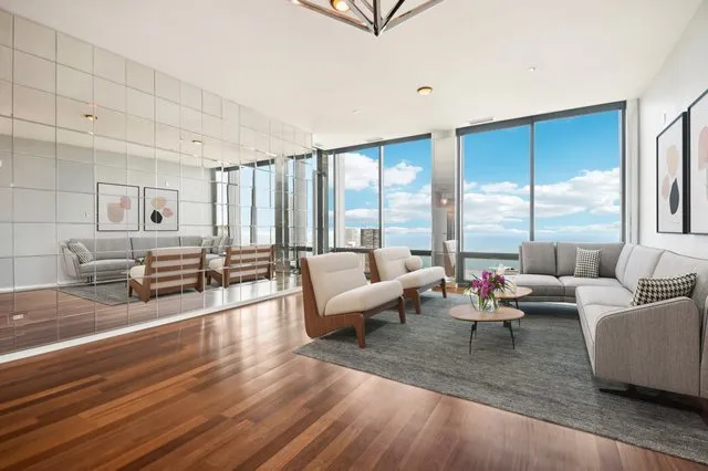 a living room with furniture and a large window